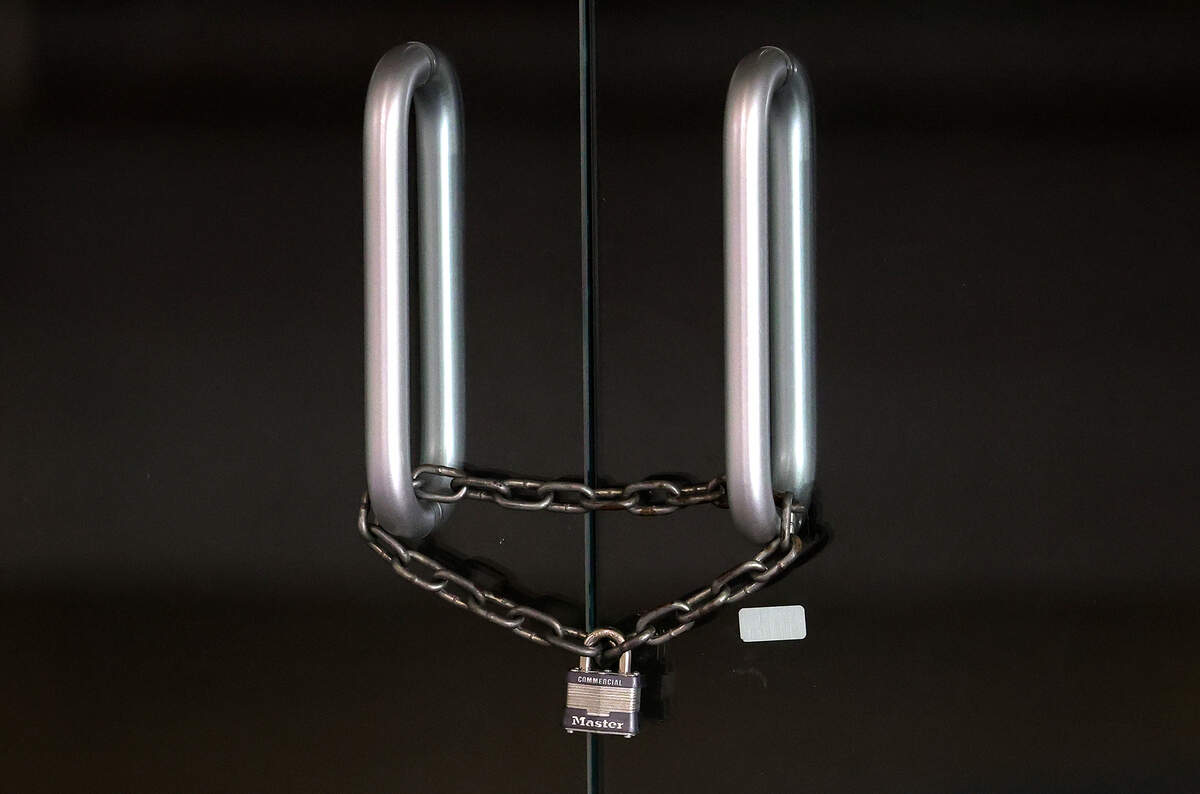 A chain locks the glass doors of a former storefront at Ridgmar Mall on Thursday, Aug. 27, 2026, in Fort Worth.